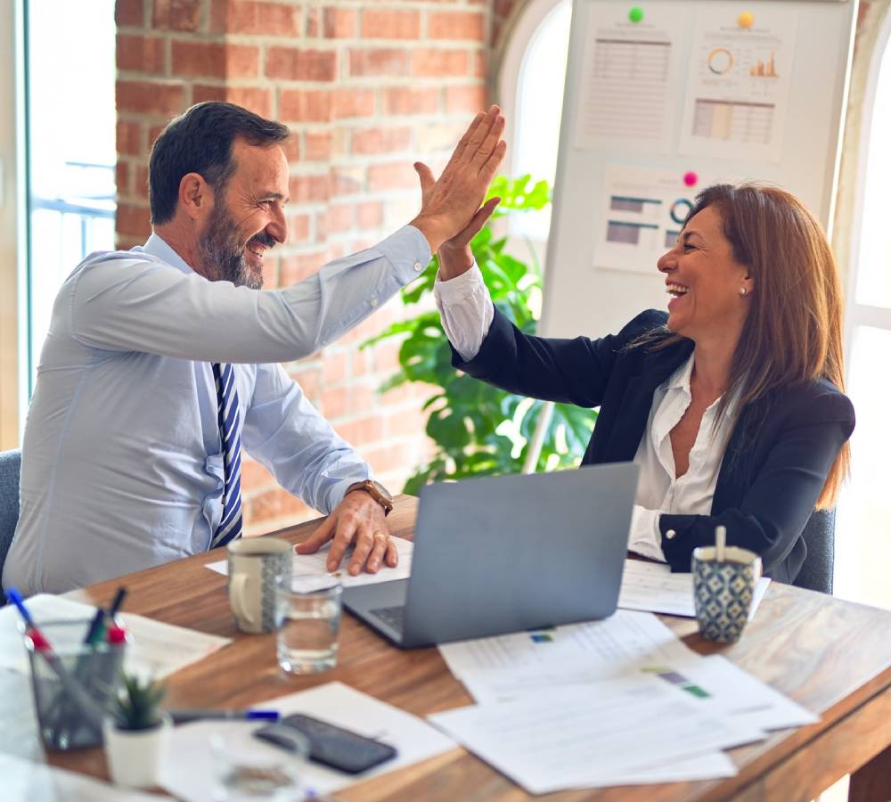 Two people High Fiving during successful collaboration